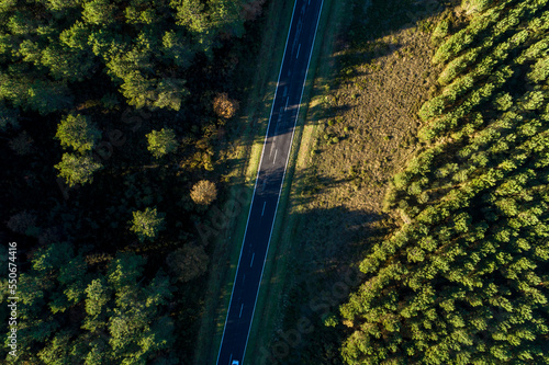 zenithal aerial view of a road with a drone at sunset