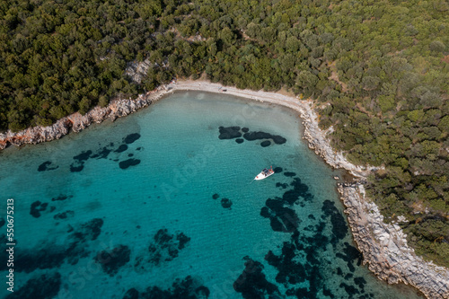 Aerial view of a small boat on the turquoise water of Mediterranean Sea