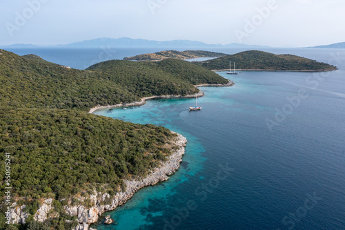 Aerial view of sailboats and luxurious yachts at the coast of Mediterranean Sea. Pine tree forest and turquoise water of Bodrum, Turkey © ern