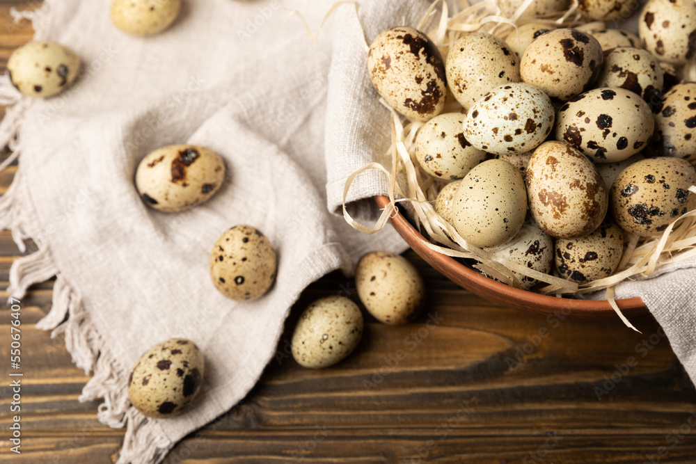 Quail eggs in a plate on a dark old brown wooden background. Eco product. Diet food. Healthy food. Space for text.Space for copy. Quail eggs in a plate on a dark old brown wooden background. Eco product. Diet food. Healthy food. Space for text.Space for copy.