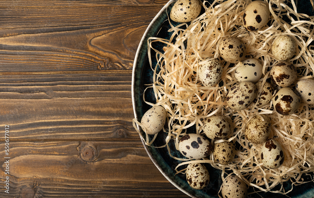 Quail eggs in a plate on a dark old brown wooden background. Eco product. Diet food. Healthy food. Space for text.Space for copy. Quail eggs in a plate on a dark old brown wooden background. Eco product. Diet food. Healthy food. Space for text.Space for copy.