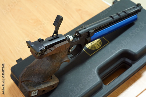 Sporting pistol. It has a wooden handle.