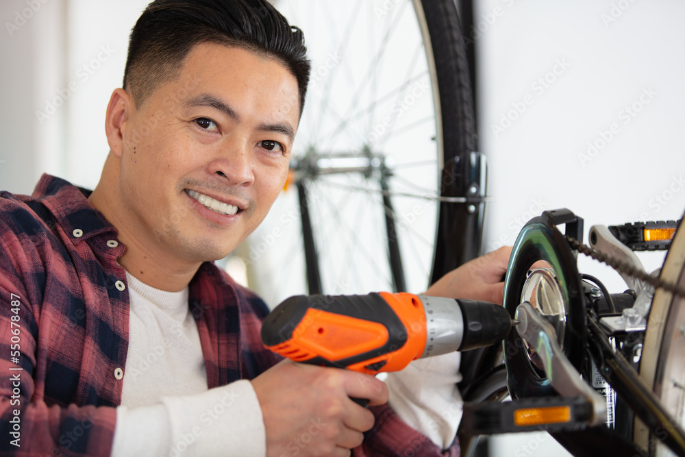 bicycle mechanic uses a cordless powertool