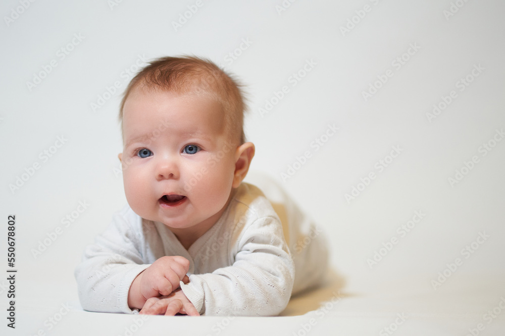 portrait of an infant lying on his back against a white background portrait of an infant lying on his back against a white background