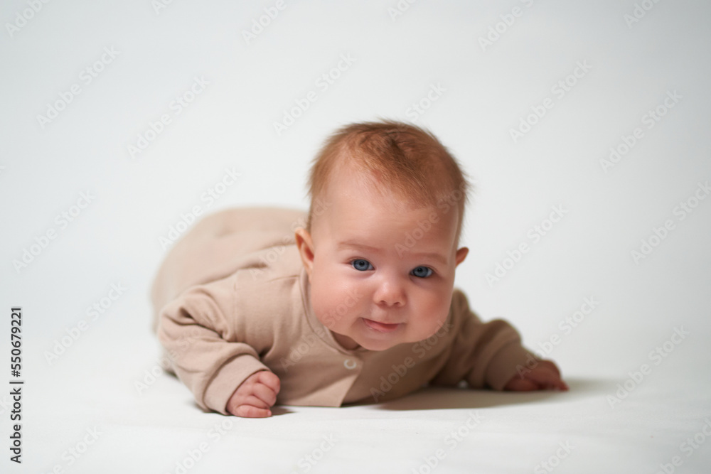 portrait of an infant looking into the camera on a white background portrait of an infant looking into the camera on a white background