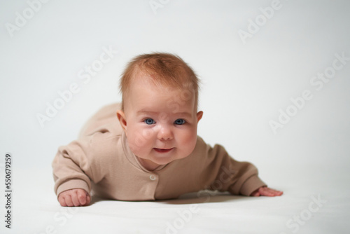 portrait of an infant looking into the camera on a white background