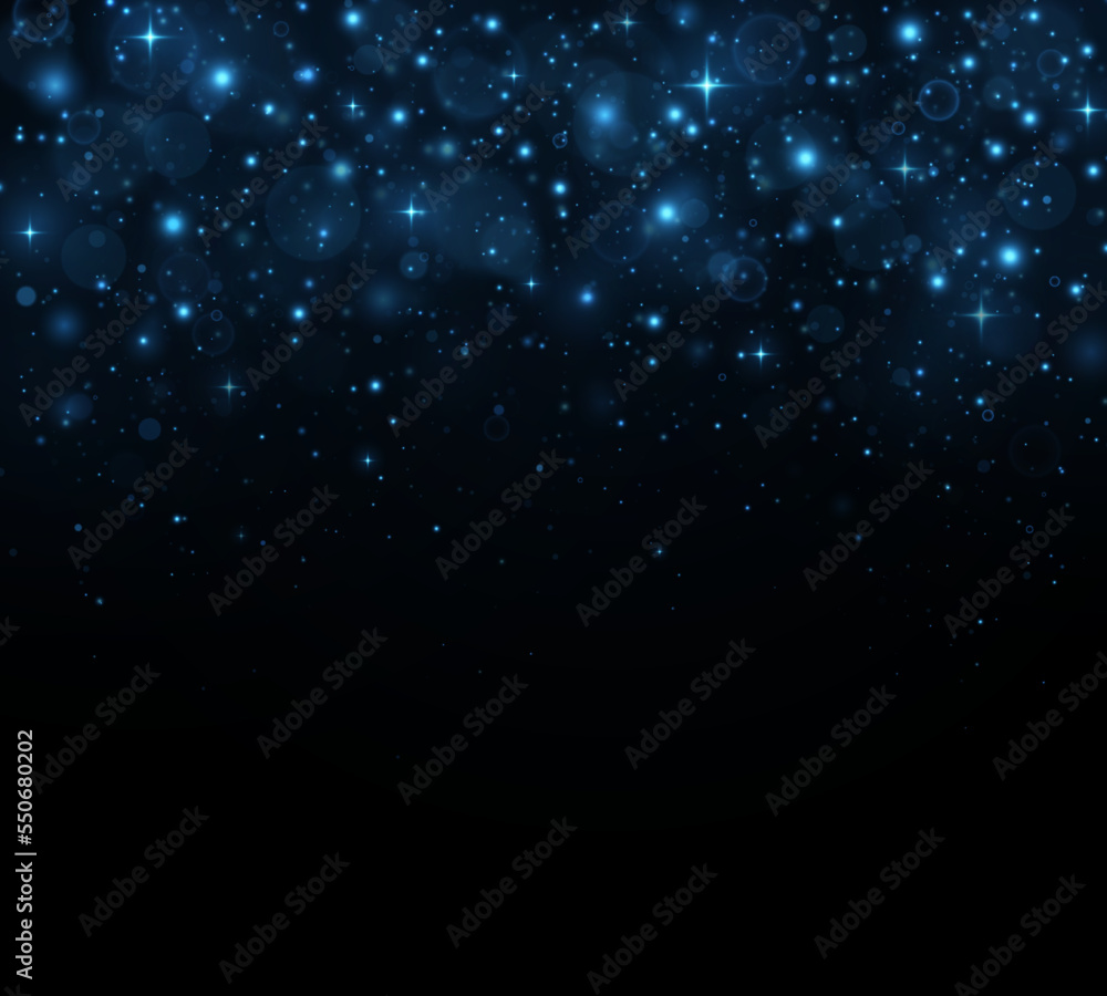 Sparkling magical dust particles. The dust sparks and blue stars shine with special light on a black background. Christmas concept.