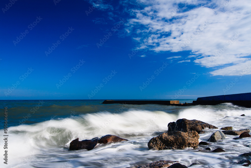 Waves breaking in the Black Sea on the rocky Bzhny coast of the Crimean peninsula, on a bright sunny day. Pure and wonderful nature of Crimea. Ukraine, territory occupied by the Russian Federation. Waves breaking in the Black Sea on the rocky Bzhny coast of the Crimean peninsula, on a bright sunny day. Pure and wonderful nature of Crimea. Ukraine, territory occupied by the Russian Federation.