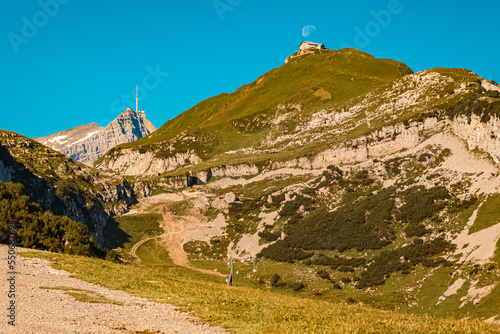 The moon passing closely over the famous Schaefler mountain inn at Ebenalp, Appenzell, Alpstein, Switzerland photo