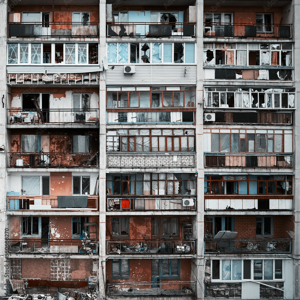 An apartment building in a war zone. Damage to a house as a result of artillery strikes. War in residential areas, broken windows and burned apartments. Armed Conflict in Ukraine