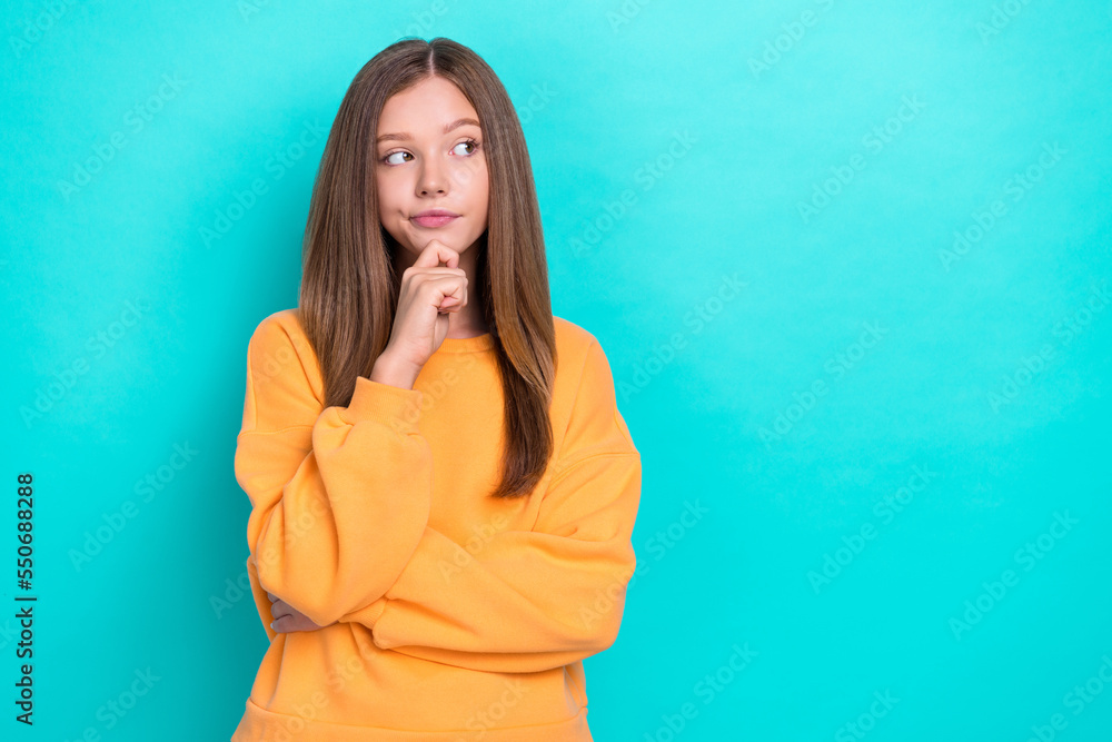 Photo of young confident schoolgirl touch chin looking mockup uncertain choose language courses online ad isolated on aquamarine color background Photo of young confident schoolgirl touch chin looking mockup uncertain choose language courses online ad isolated on aquamarine color background