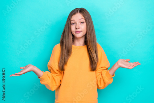 Photo of beautiful schoolgirl teenager wear yellow trendy pullover shrug shoulders dont know where money stolen isolated on cyan color background