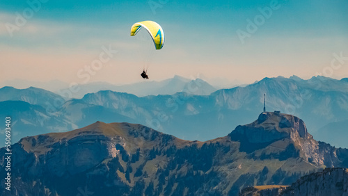 Beautiful alpine summer view with a paraglider at the famous Ebenalp, Appenzell, Alpstein, Switzerland