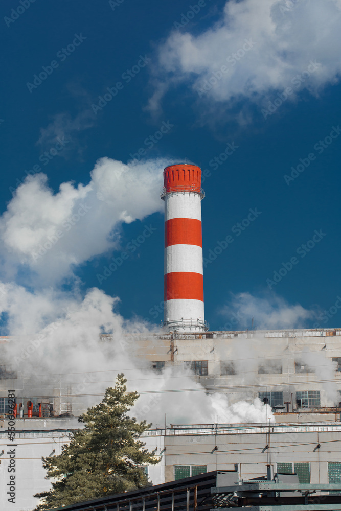 Pollution of the surrounding environment, nature, ecology, air. Industrial plant pipe emits toxic acrid smoke produced by the plant Pollution of the surrounding environment, nature, ecology, air. Industrial plant pipe emits toxic acrid smoke produced by the plant