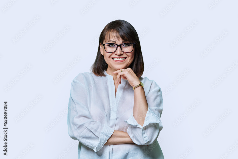 Portrait of beautiful smiling middle aged woman on white background Portrait of beautiful smiling middle aged woman on white background