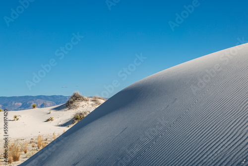 Gypsum sand dunes in White Sands Desert, with a blue sky overhead