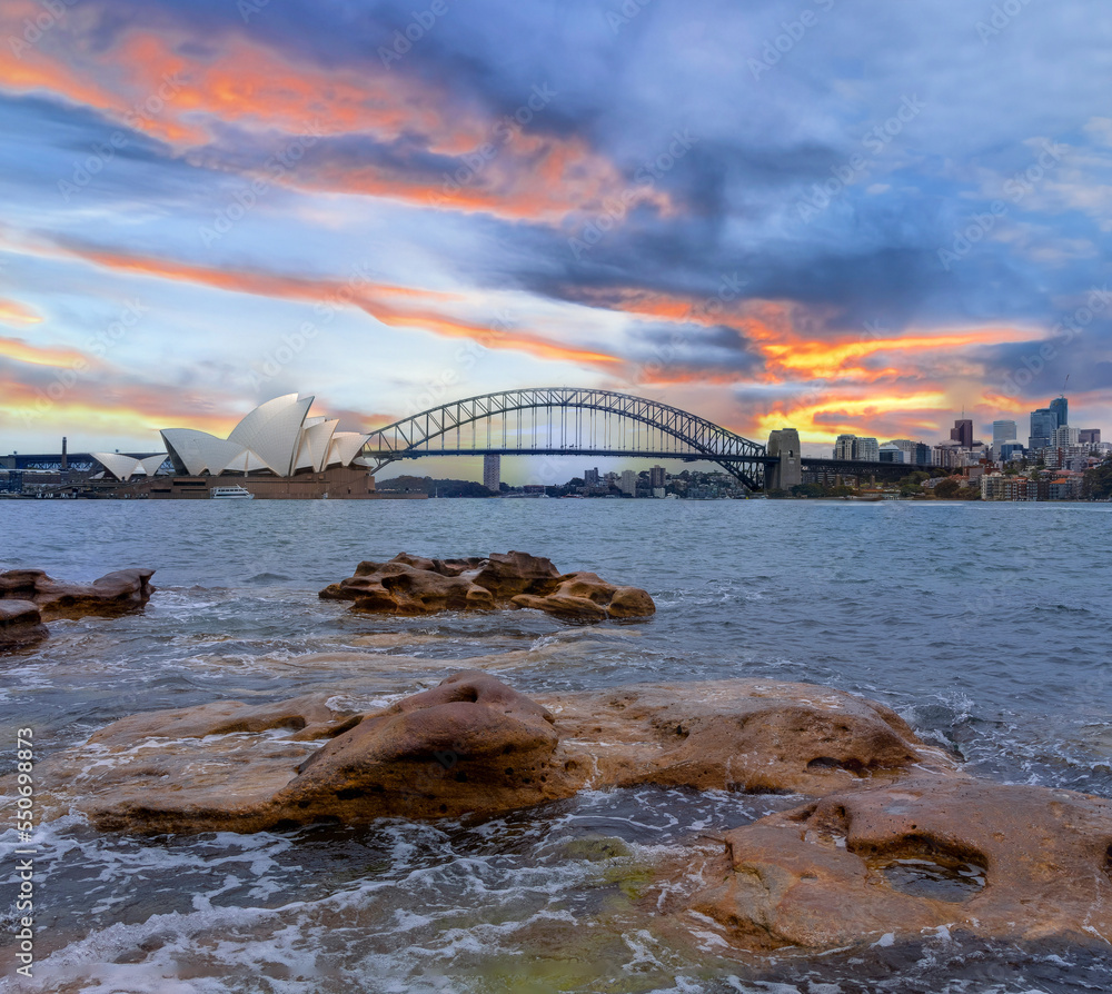 Obraz premium Sydney Harbour Australia at Sunset with the turquoise colours of the bay and high rise offices of the City in the background