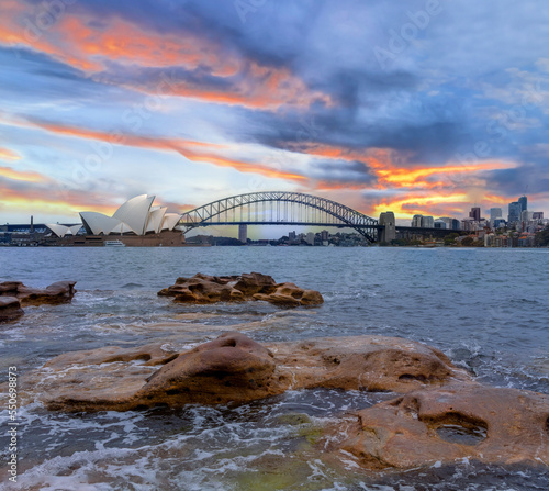 Sydney Harbour Australia at Sunset with the turquoise colours of the bay and high rise offices of the City in the background © Elias Bitar