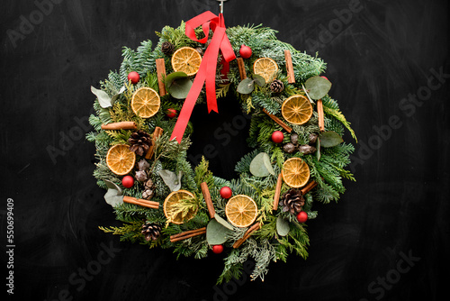 awesome beautiful wreath decorated with dry orange slices balls and ribbon