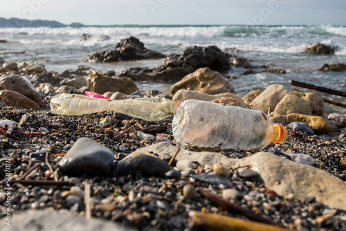 Heraklion, Crete Island, Greece. April 19, 2021: Poluted beach with plastic empty bottles photo