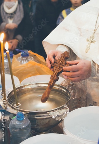 Obraz na plátně Consecration of water with a wooden cross in church