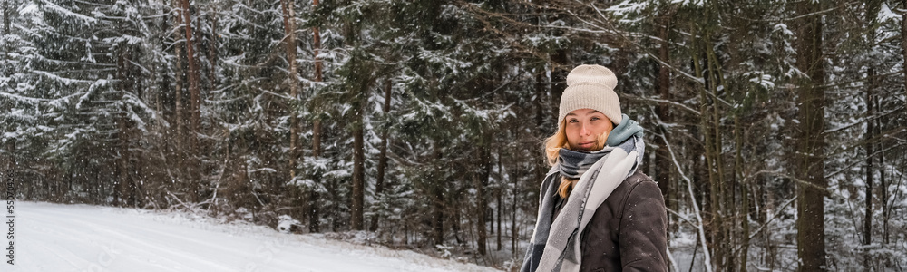 Winter.woman walks through winter snowy forest. Mental and physical health. Unity with nature.travel outdoors, hiking, spending time outdoors,winter travel,slow life,christmas forest.