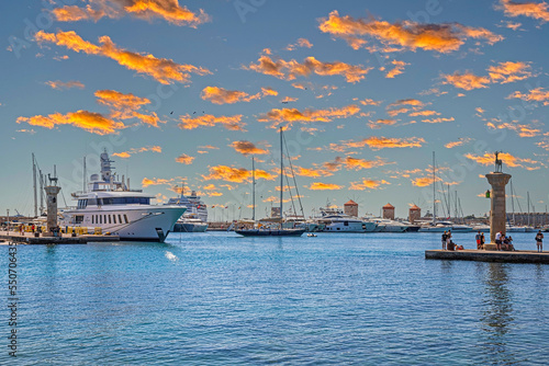 Afternoon view with the Mandraki Marina Port, symbolic deer doe statues where the Colossus of Rhodes stood. Rhodes, Greece