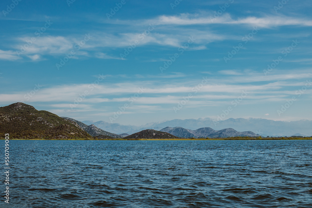 Amazing view of Skadar Lake and beautiful mountains on a sunny morning. Amazing view of Skadar Lake and beautiful mountains on a sunny morning.