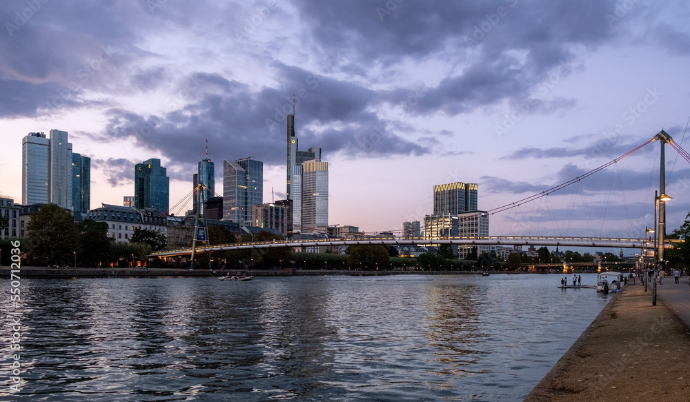 skyscrapers by the river at sunset. cities and buildings at sunset.