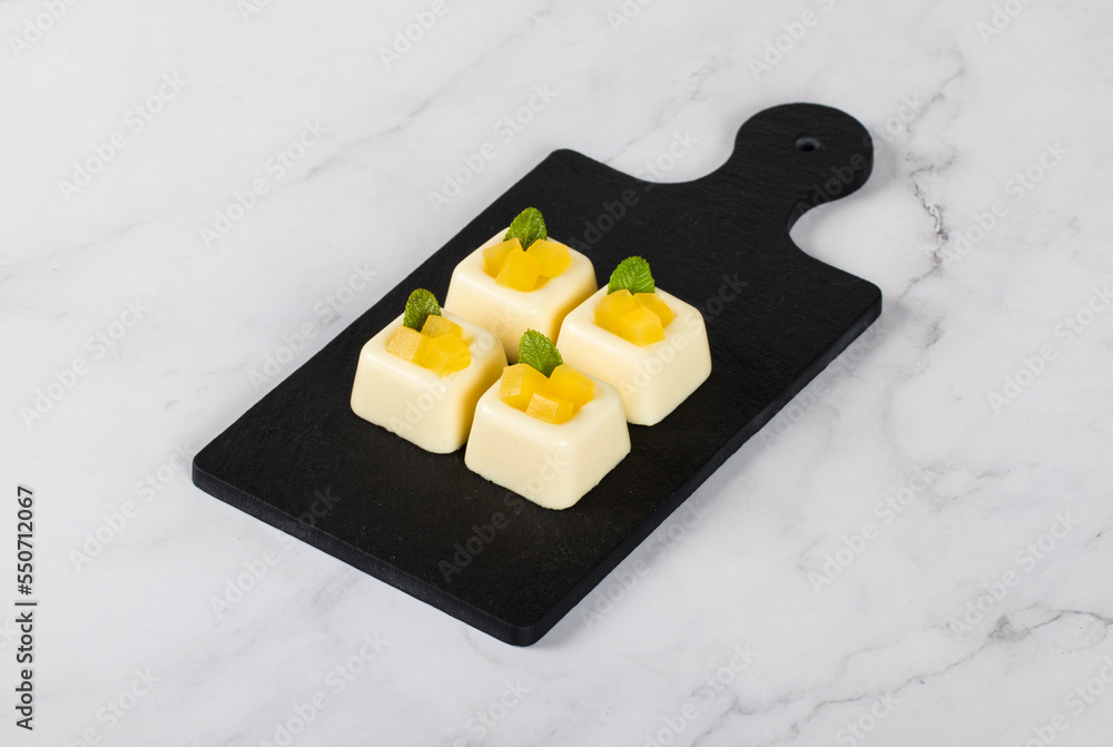 Mango cream jelly pudding, Panna Cotta in the form of small square ... Mango cream jelly pudding, Panna Cotta in the form of small square ...