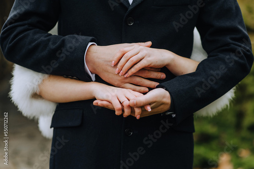 Hands, fingers of the bride and groom, man and woman together close-up. © shchus