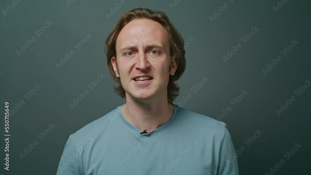 An aggressive man yelling into the camera and waving his hands. Man with headache and experiences. Serious, angry, and neutral facial expressions. active gesticulation. emotional movements. An aggressive man yelling into the camera and waving his hands. Man with headache and experiences. Serious, angry, and neutral facial expressions. active gesticulation. emotional movements.