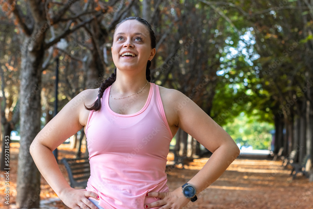 Portrait of smiling woman after running. Healthy runner resting after workout exercise and looking at camera. Active sporty woman enjoying outdoors in autumn. Portrait of smiling woman after running. Healthy runner resting after workout exercise and looking at camera. Active sporty woman enjoying outdoors in autumn.