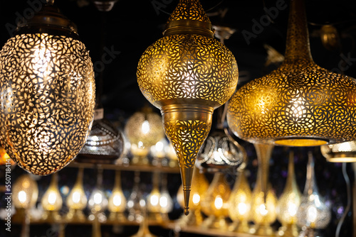 Bright openwork hanging metal lamps of an unusual shape photo