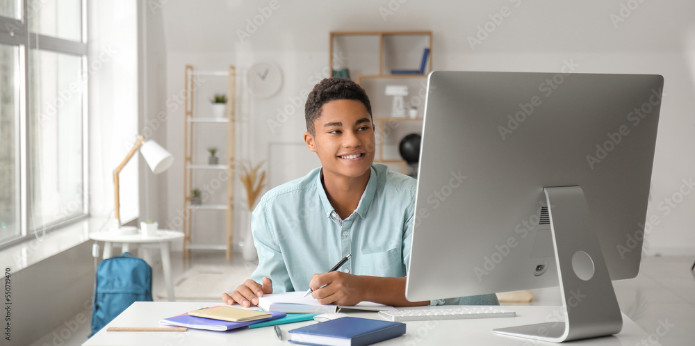 African-American student studying online at home African-American student studying online at home