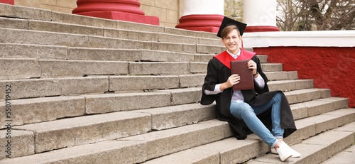 Male graduating student sit...
