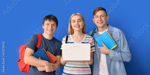 Students with laptop on blu...