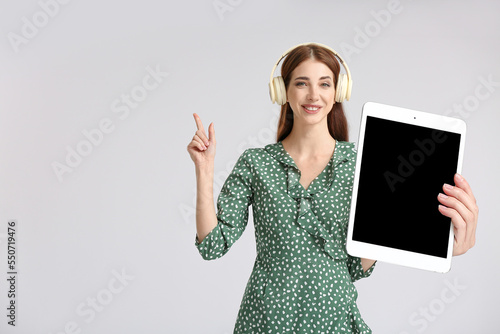 Young woman with big tablet...