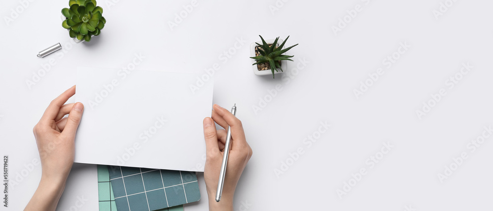 Female hands with blank paper sheet, pen and notebooks on white background with space for text Female hands with blank paper sheet, pen and notebooks on white background with space for text