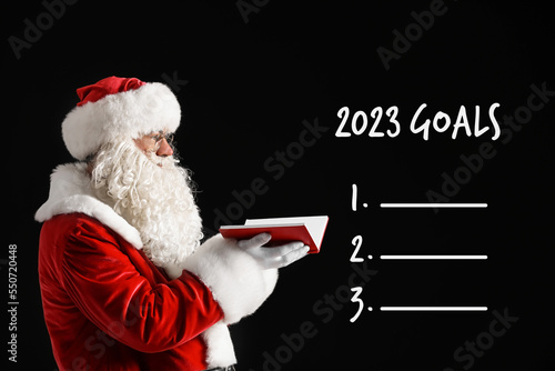 Santa Claus with notebook a...