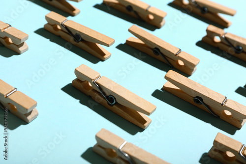 Wooden clothespins on blue background, closeup