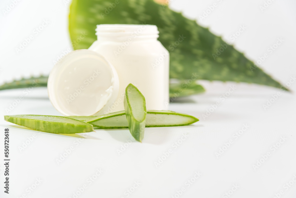 pieces of Aloe Vera leaves and a plastic container on a table pieces of Aloe Vera leaves and a plastic container on a table