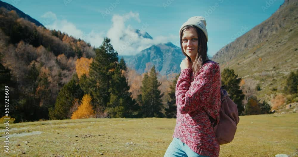 Tourist walk on mountain path at vacation trip watching to camera and smile Tourist walk on mountain path at vacation trip watching to camera and smile