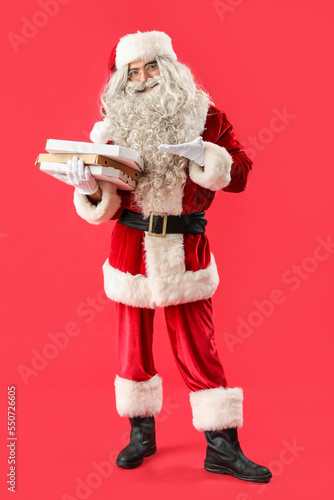 Santa Claus holding boxes w...