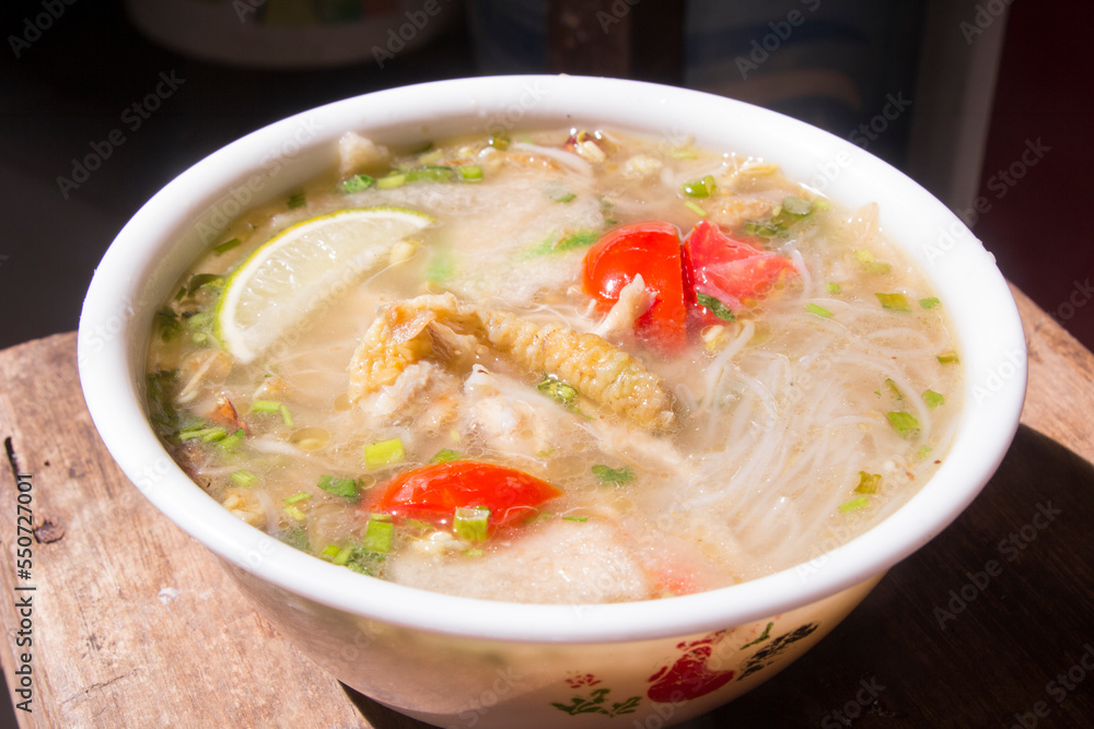 Soto lamongan, East Java soup with main ingredients of chicken, white noodles and fried onions. mixed with lime