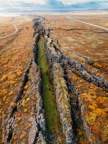 Two tectonic plates meeting on the surface of Earth in a long straight line in Thingvellir National Park photo