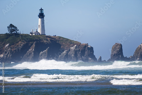 Lighthouse On Cliff Oregon Coast With Waves