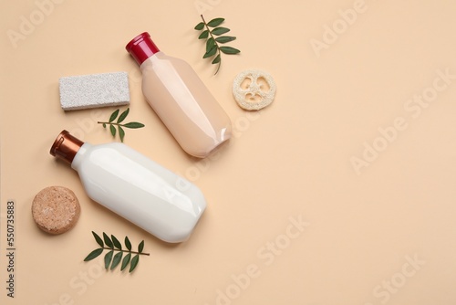 Flat lay composition with solid shampoo bar and bottles of cosmetic product on beige background  space for text