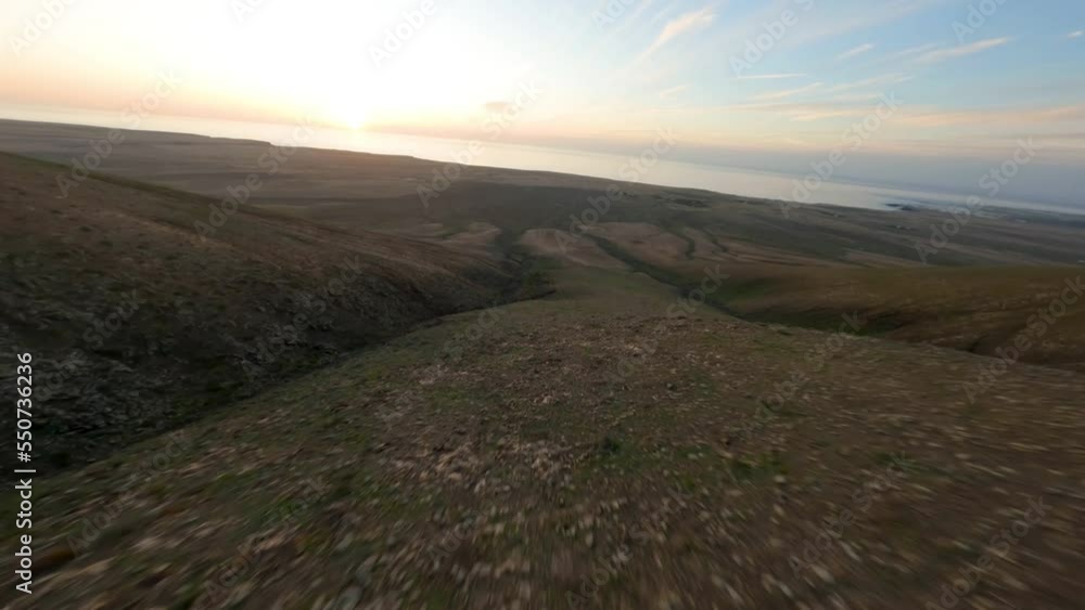 fuerteventura east coast fpv mountain dive during sunset beautiful smooth mountain landscape fuerteventura east coast fpv mountain dive during sunset beautiful smooth mountain landscape