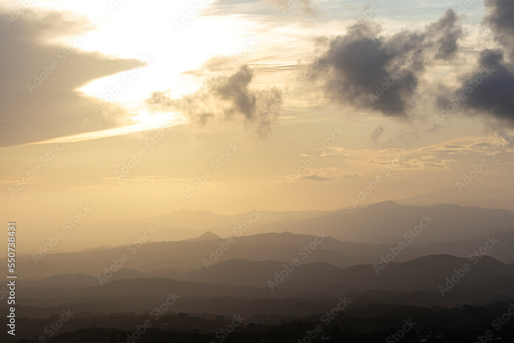 View of a beautiful golden sunset over a mountain range